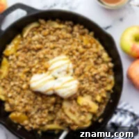 This skillet caramel apple crisp features tender apple slices in a rich homemade caramel sauce and topped with a buttery oat streusel topping. Enjoy this classic fall dessert warm from the oven with vanilla ice cream or whipped cream!