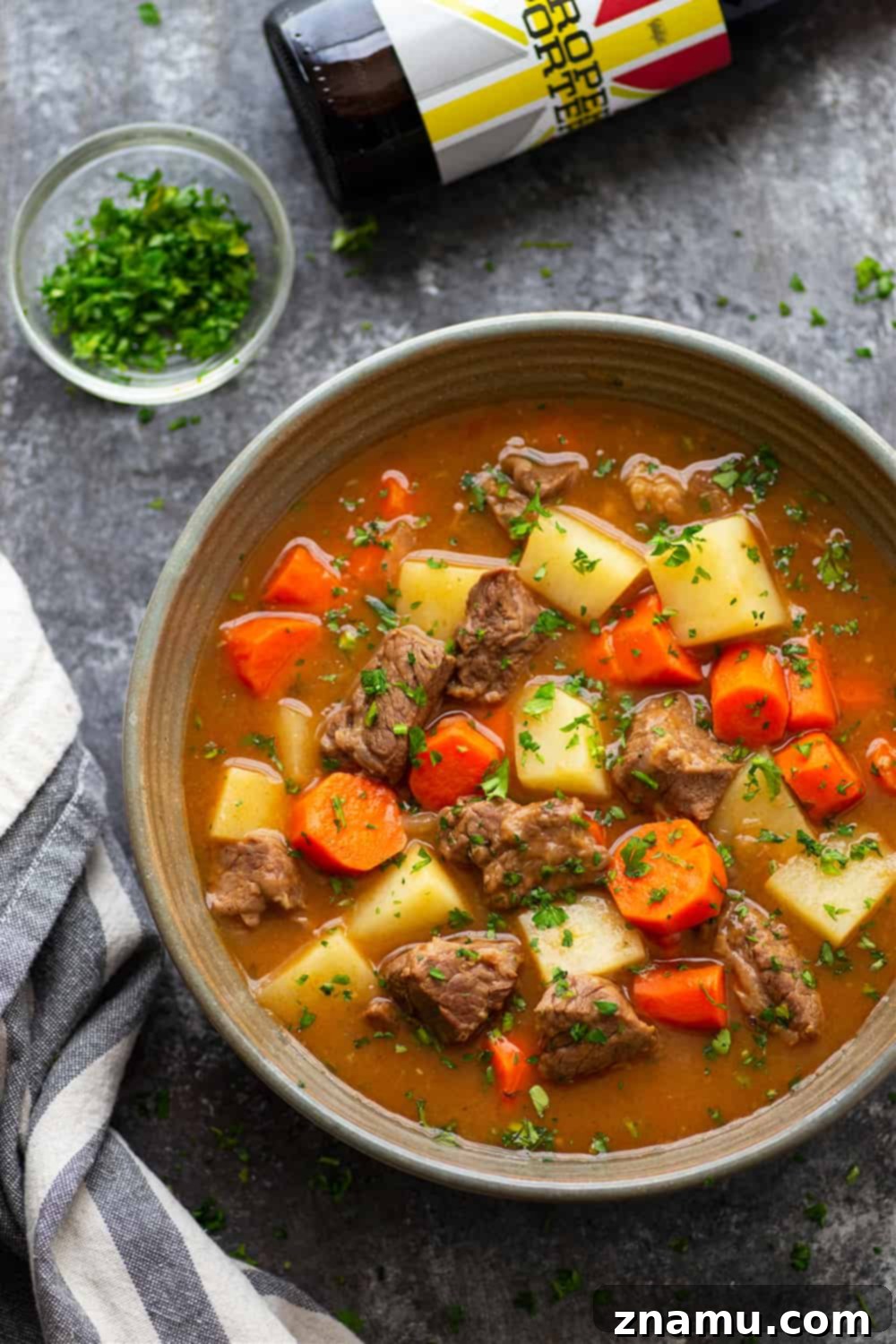 Rich Instant Pot Irish Beef Stew 4 Bowl of Instant Pot Irish Beef Stew with herbs on top, ready to serve.