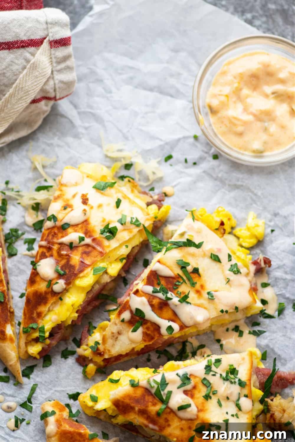 Rise and Shine Corned Beef Quesadillas 3 Crispy breakfast corned beef quesadillas with a side of Thousand Island dressing, perfect for using up leftover corned beef.