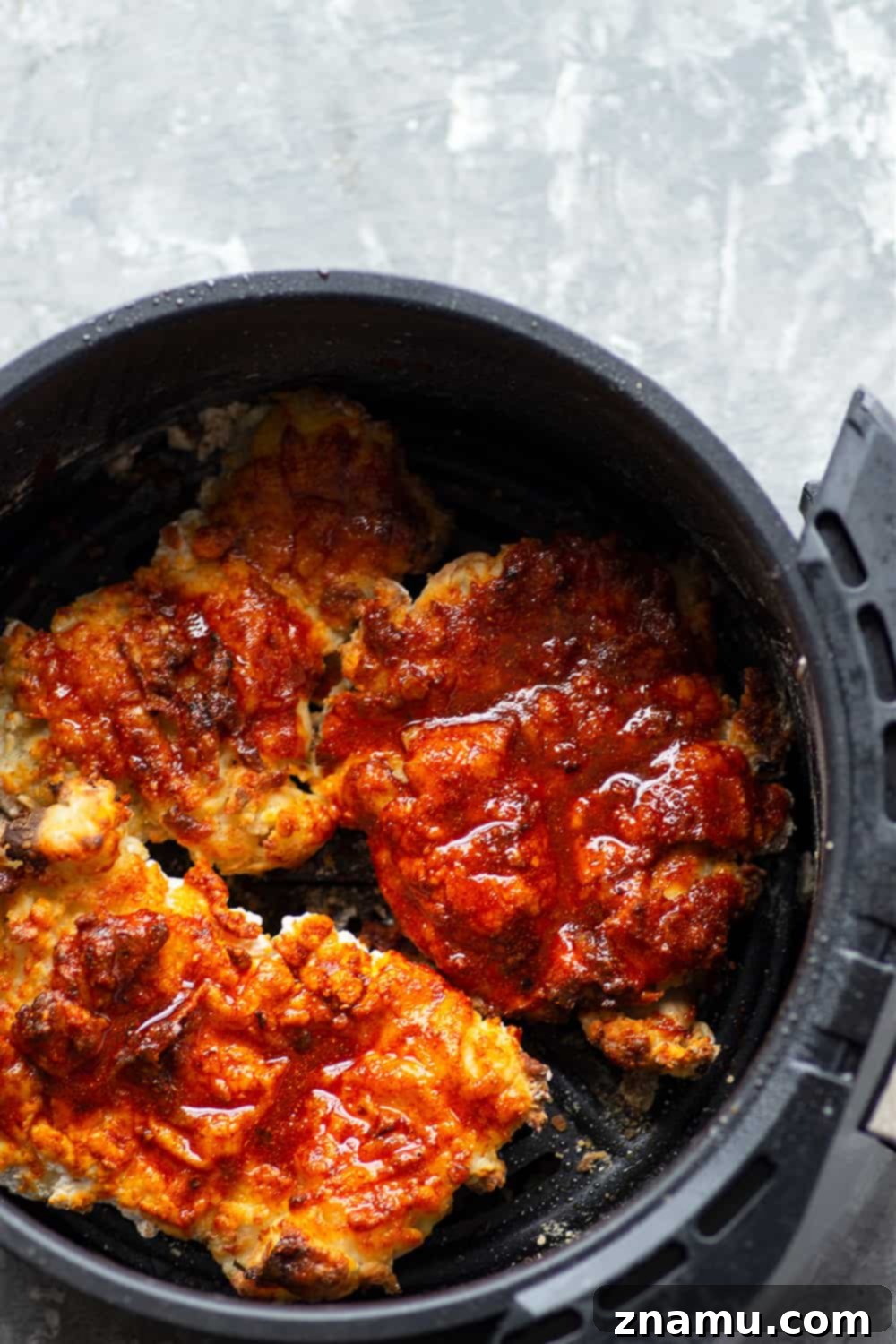 Air fryer Nashville hot chicken is a healthier version of the classic spicy fried chicken! Crispy buttermilk-soaked chicken thighs are fried until perfectly crispy and brushed in a spicy cayenne sauce.