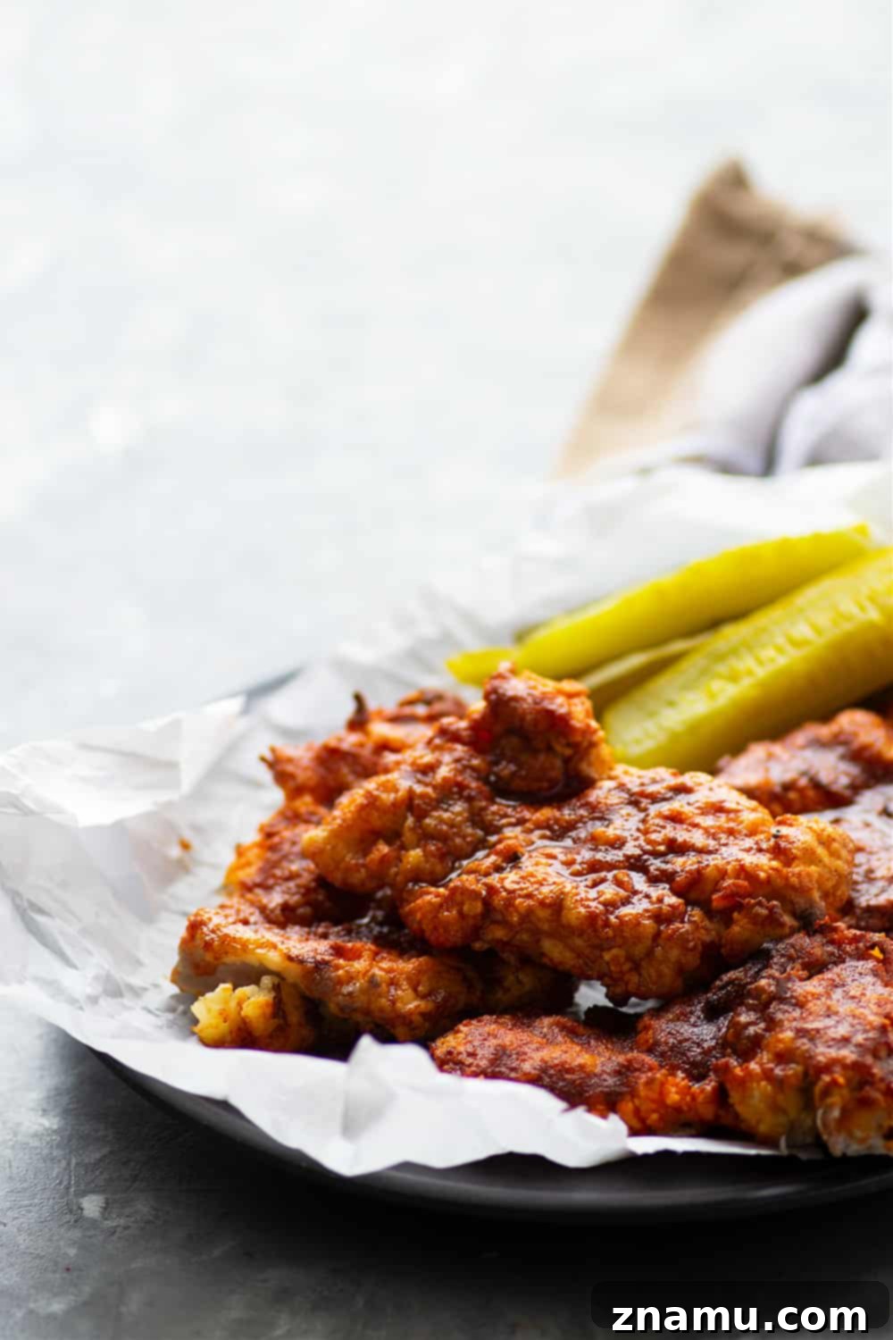 Air fryer Nashville hot chicken is a healthier version of the classic spicy fried chicken! Crispy buttermilk-soaked chicken thighs are fried until perfectly crispy and brushed in a spicy cayenne sauce.