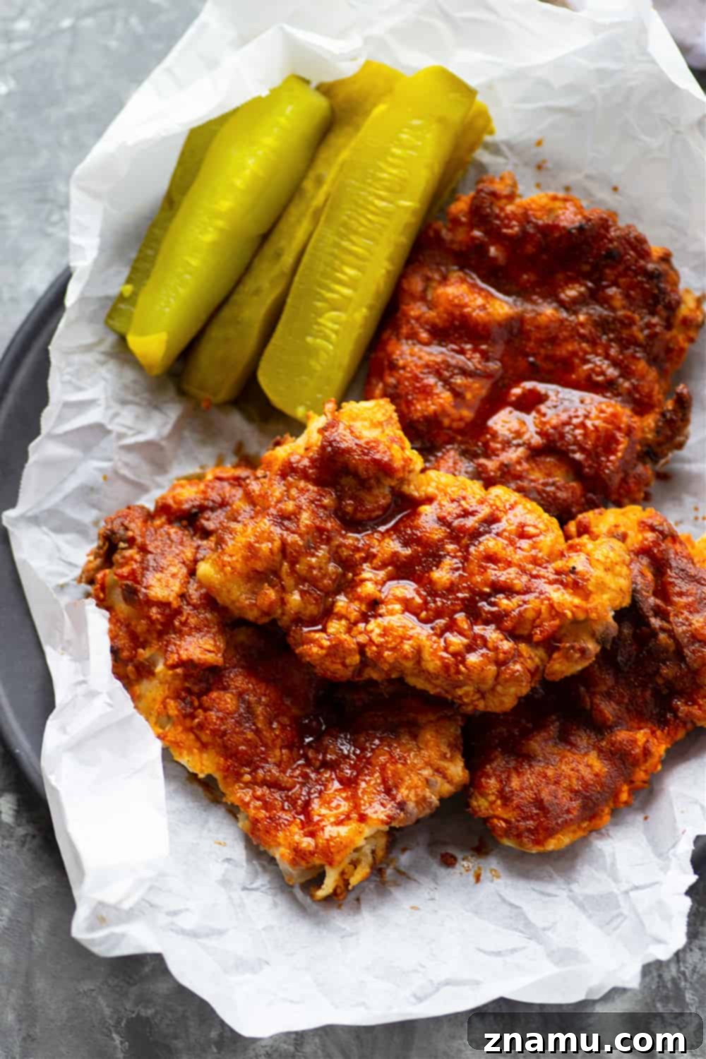 Air fryer Nashville hot chicken is a healthier version of the classic spicy fried chicken! Crispy buttermilk-soaked chicken thighs are fried until perfectly crispy and brushed in a spicy cayenne sauce.