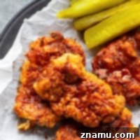 Air fryer Nashville hot chicken is a healthier version of the classic spicy fried chicken! Crispy buttermilk-soaked chicken thighs are fried until perfectly crispy and brushed in a spicy cayenne sauce.