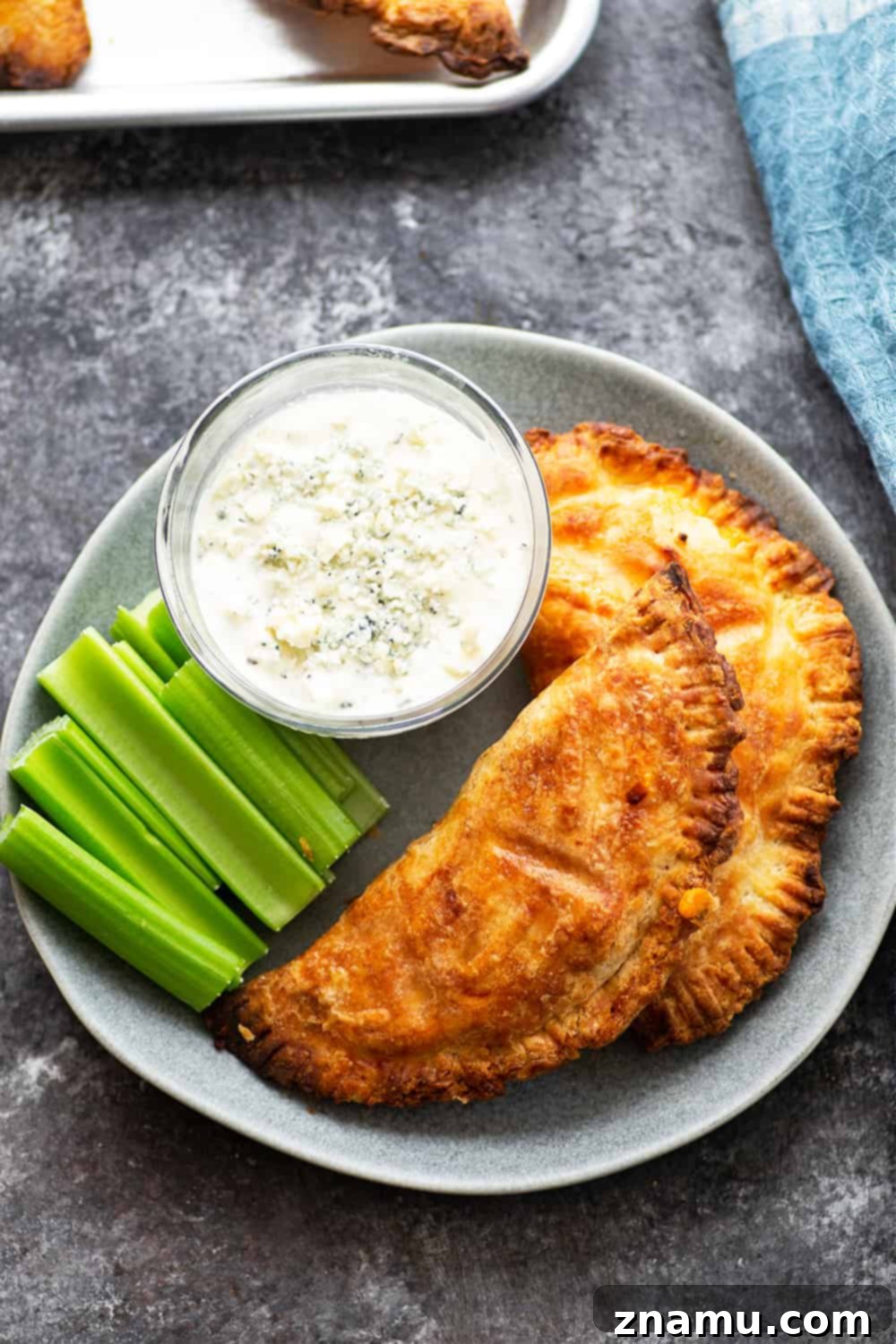 Crispy Air-Fried Buffalo Chicken Empanadas 4 Ingredients laid out for homemade Air Fryer Buffalo Chicken Empanadas: dough, shredded chicken, hot sauce, and cheeses.