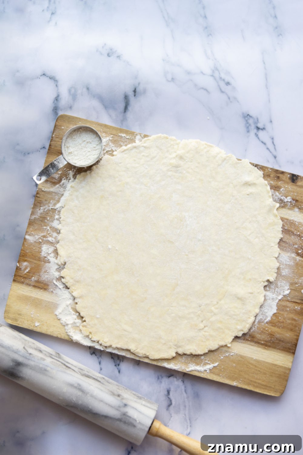 Foolproof Pie Crust 7 A golden brown, blind-baked pie crust in a metal pie plate, cooling on a wire rack.