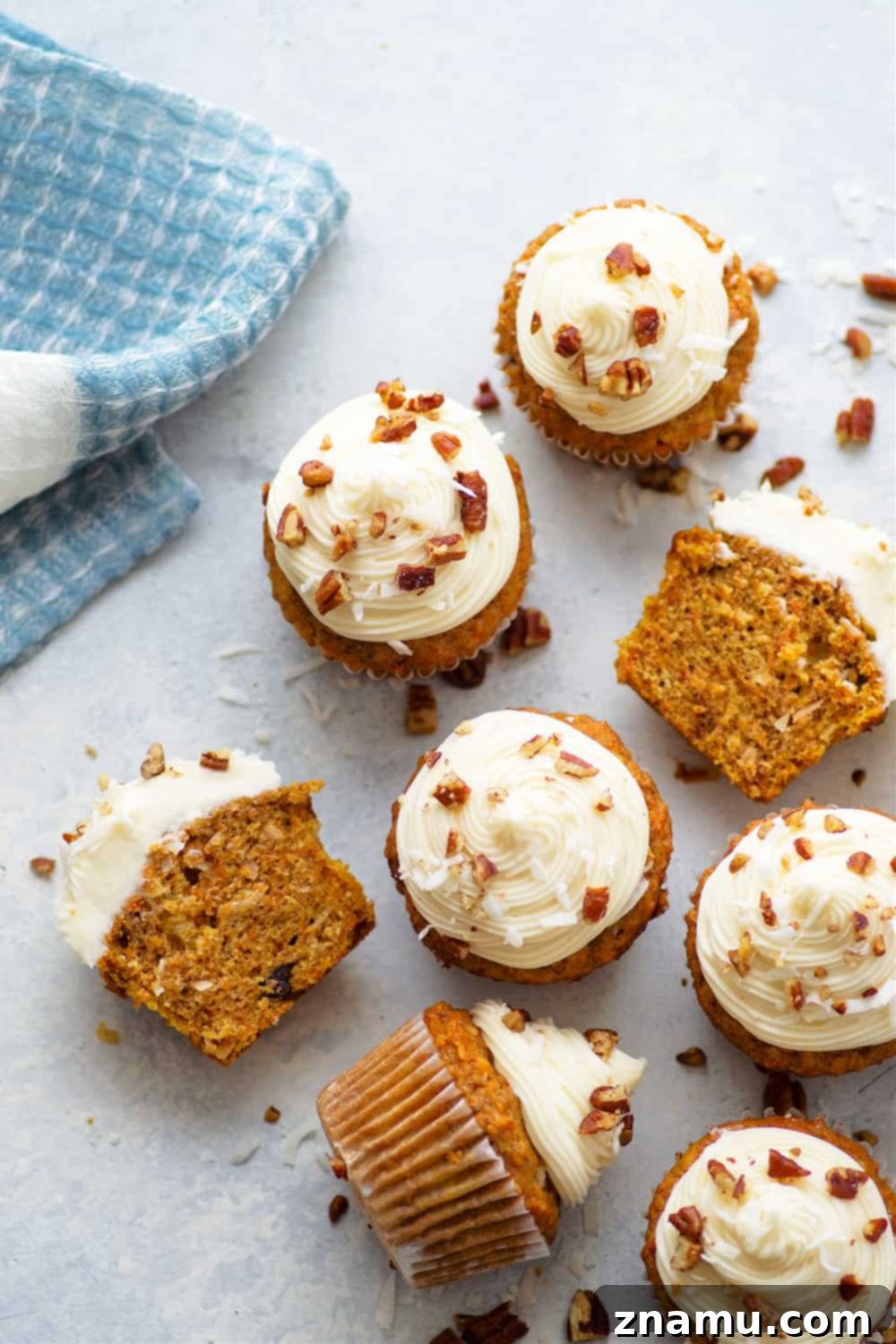Exquisitely moist Coconut Carrot Cake Cupcakes featuring browned butter, toasted nuts, flaked coconut, and a rich cream cheese frosting.