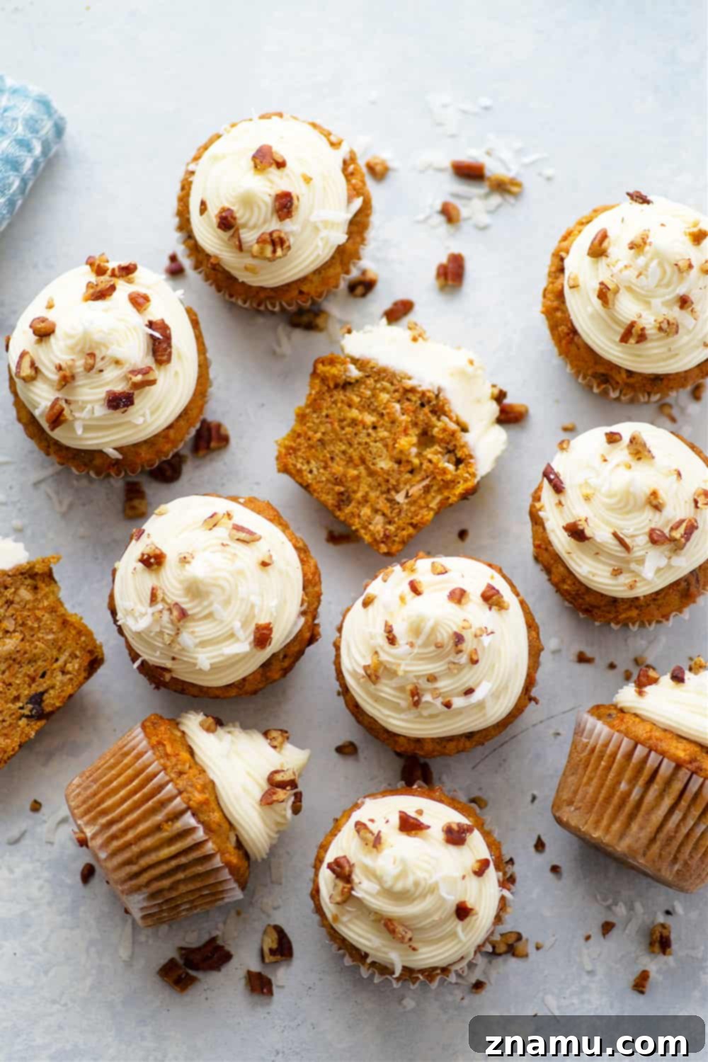 A batch of un-frosted Coconut Carrot Cake Cupcakes cooling on a wire rack.