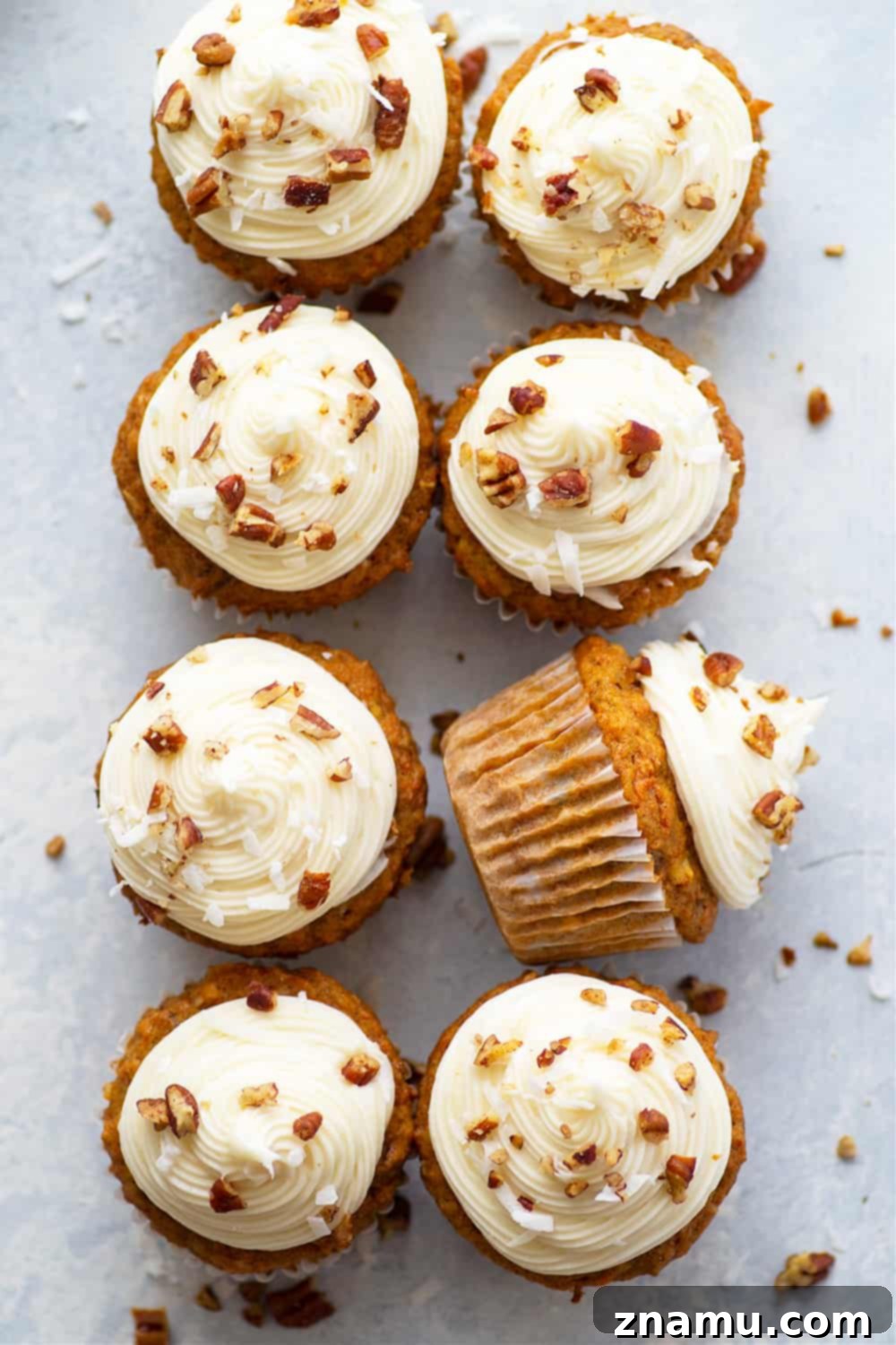 A perfectly frosted Coconut Carrot Cake Cupcake, ready to be enjoyed.