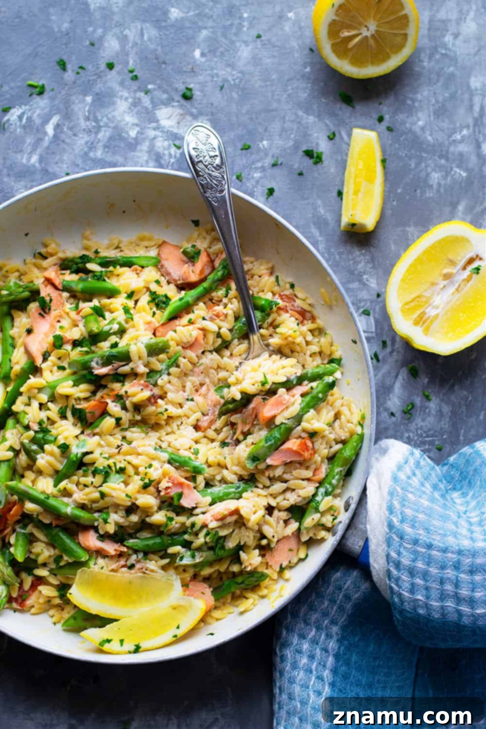 Lemon Velvet Orzo with Smoked Salmon and Asparagus 5 Creamy lemon orzo skillet with smoked salmon and asparagus, garnished with fresh parsley.