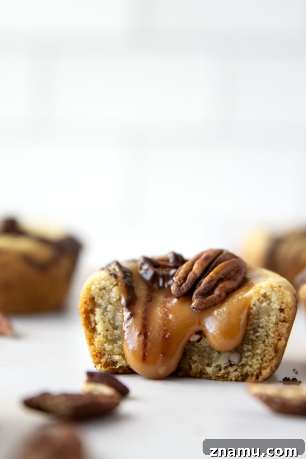 Decadent Turtle Cookie Cups 6 These soft and chewy turtle cookie cups feature a soft butter cookie cup filled with toasted pecans, salted caramel, and a luscious drizzle of melted chocolate.