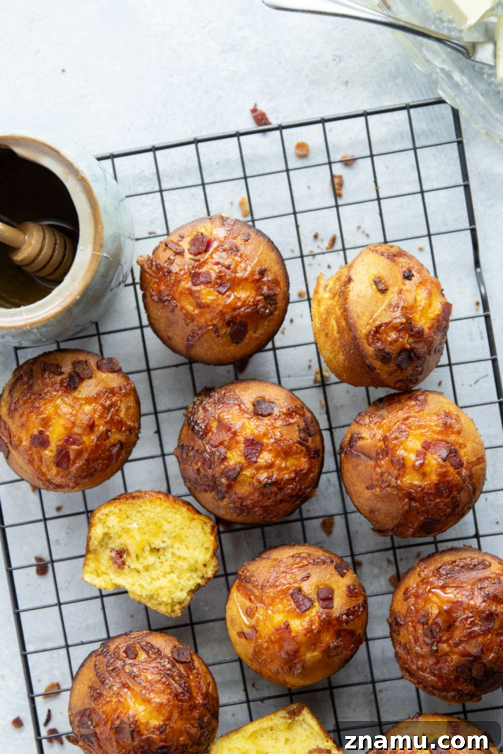 Loaded Bacon Cheddar Cornbread Muffins 3 Close-up of golden cornbread muffins with melted cheddar and bacon