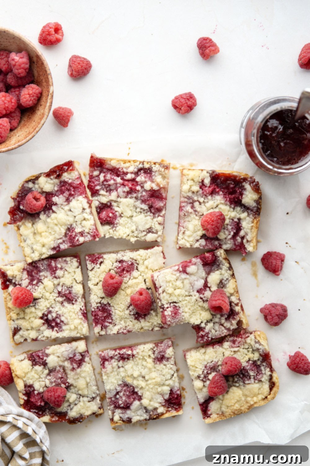 Crimson Shortbread Delights 4 Individual raspberry shortbread bar on a white plate, showcasing the layers.