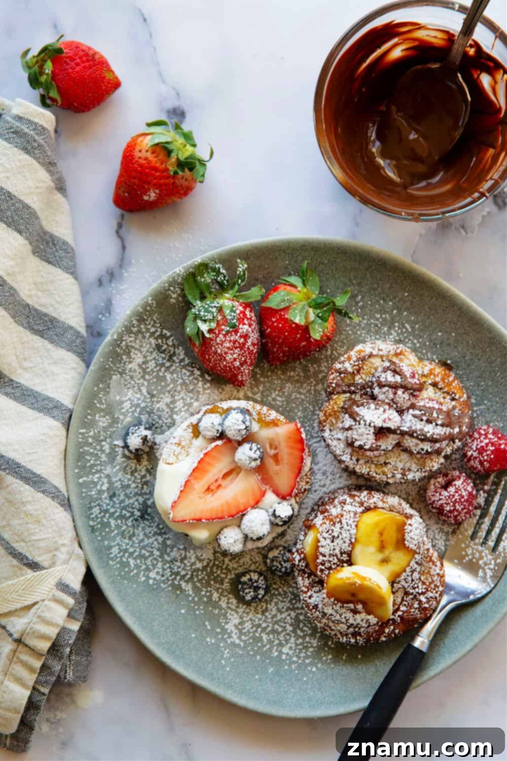 Mini Dutch Baby Bites 2 Delightful Mini Dutch Baby Pancakes: A perfect individual portion of buttery, tender puffed pancakes, ready to be filled with your favorite sweet or savory toppings for an unforgettable brunch experience.