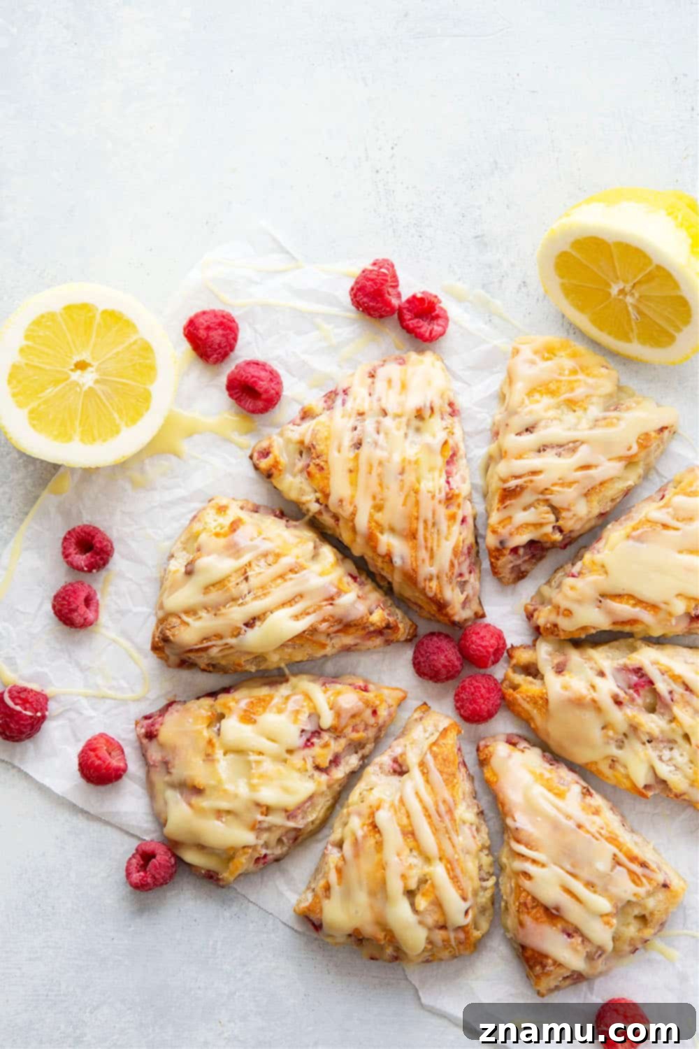Zesty Lemon Raspberry Scones with Sweet White Chocolate Glaze 2 Perfectly flaky and loaded with juicy raspberries and tangy lemon flavor, these lemon raspberry scones are glazed in a rich white chocolate glaze and a beautiful addition to any brunch!