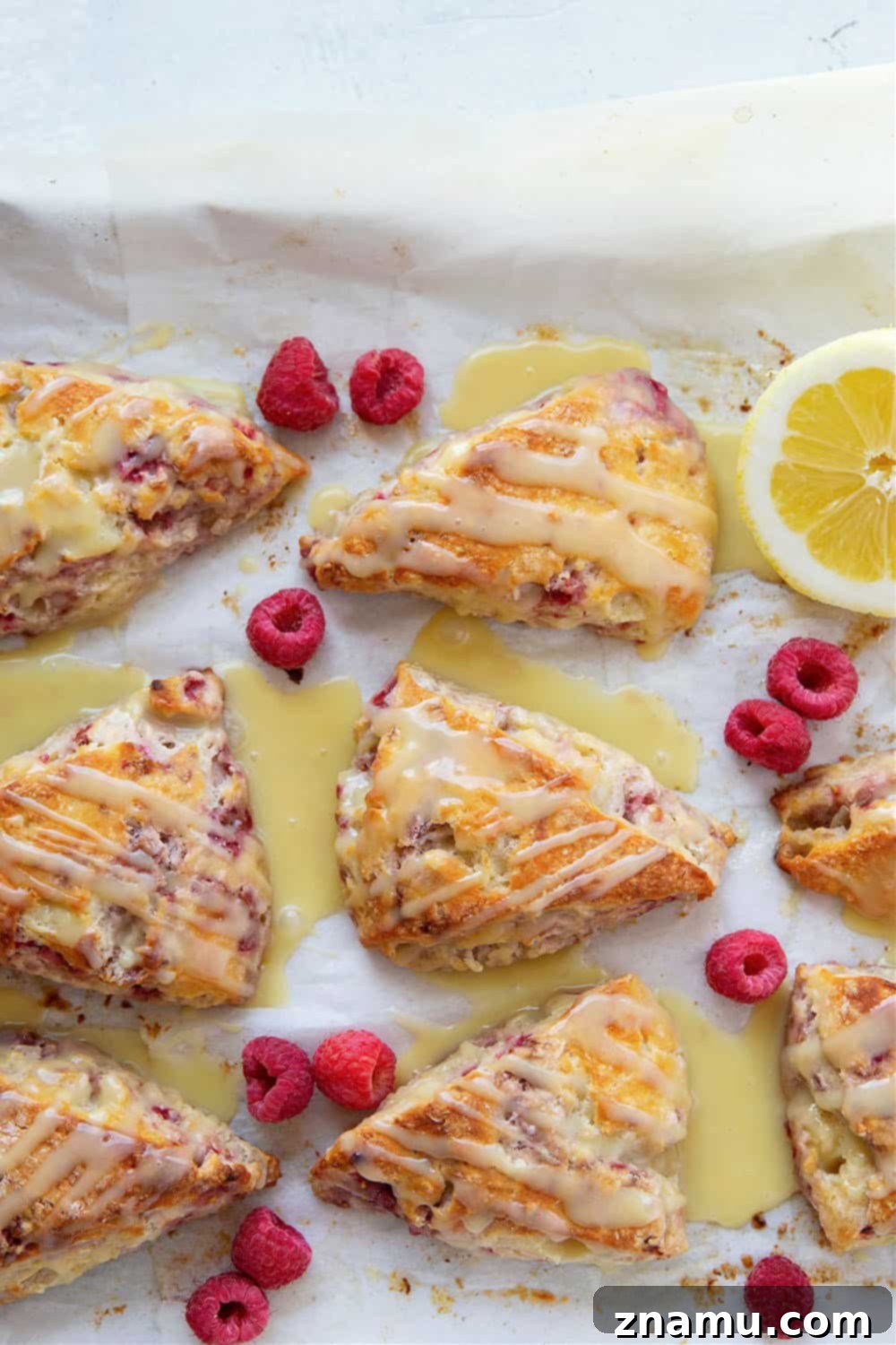 Zesty Lemon Raspberry Scones with Sweet White Chocolate Glaze 3 Perfectly flaky and loaded with juicy raspberries and tangy lemon flavor, these lemon raspberry scones are glazed in a rich white chocolate glaze and a beautiful addition to any brunch!