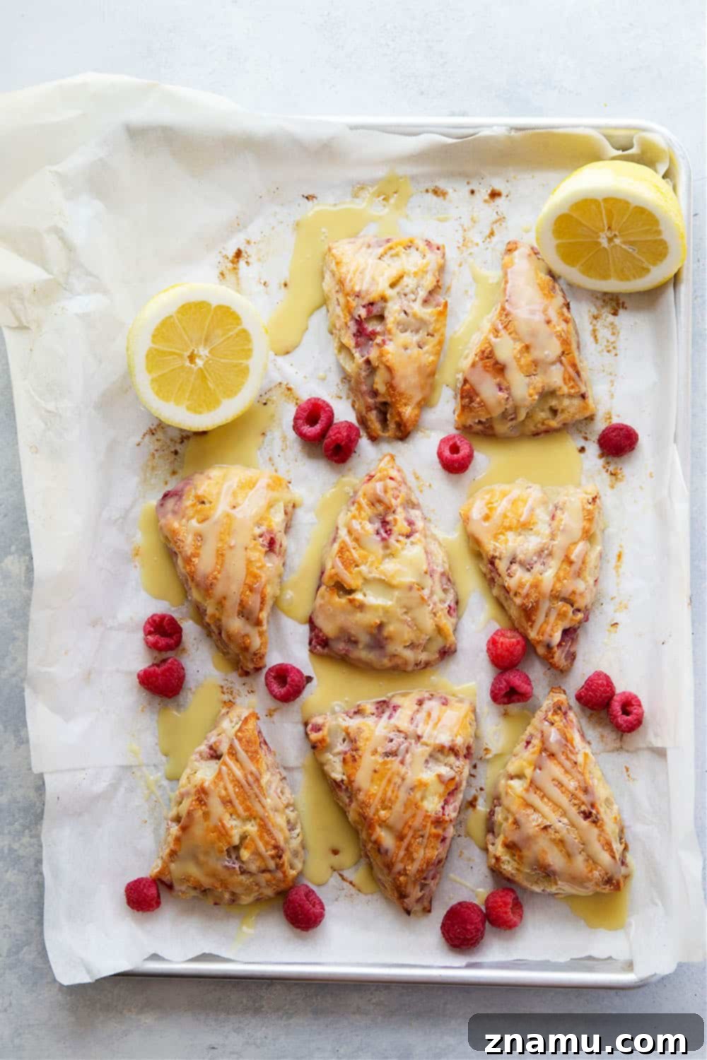 Zesty Lemon Raspberry Scones with Sweet White Chocolate Glaze 4 Perfectly flaky and loaded with juicy raspberries and tangy lemon flavor, these lemon raspberry scones are glazed in a rich white chocolate glaze and a beautiful addition to any brunch!
