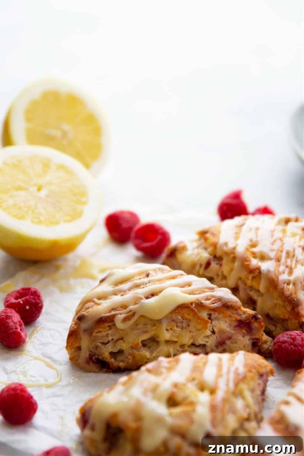 Zesty Lemon Raspberry Scones with Sweet White Chocolate Glaze 5 Perfectly flaky and loaded with juicy raspberries and tangy lemon flavor, these lemon raspberry scones are glazed in a rich white chocolate glaze and a beautiful addition to any brunch!