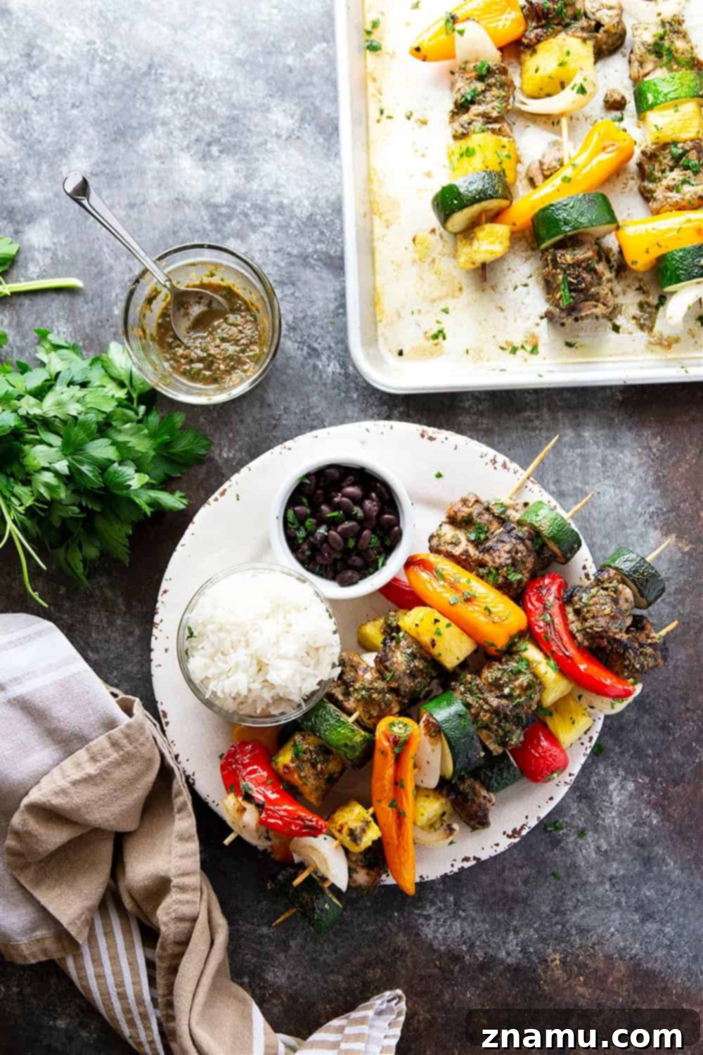 Grilled jerk chicken kabobs feature a spicy homemade jerk marinade coating juicy chicken thighs, sweet pineapple, and fresh vegetables.