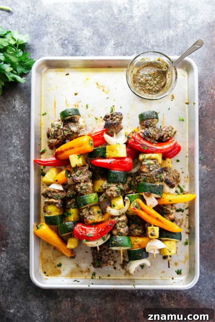 Grilled jerk chicken kabobs feature a spicy homemade jerk marinade coating juicy chicken thighs, sweet pineapple, and fresh vegetables.