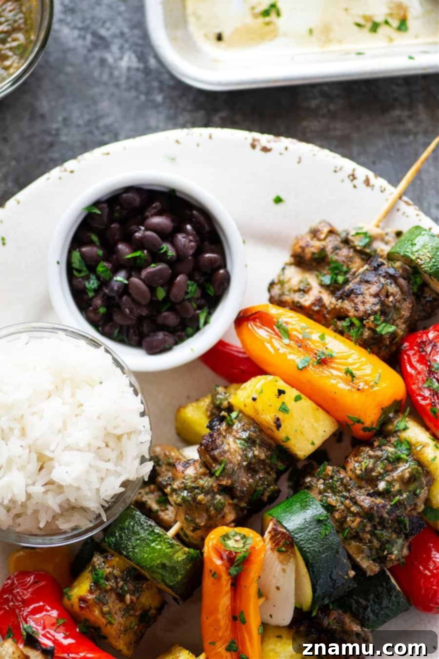 Grilled jerk chicken kabobs feature a spicy homemade jerk marinade coating juicy chicken thighs, sweet pineapple, and fresh vegetables.