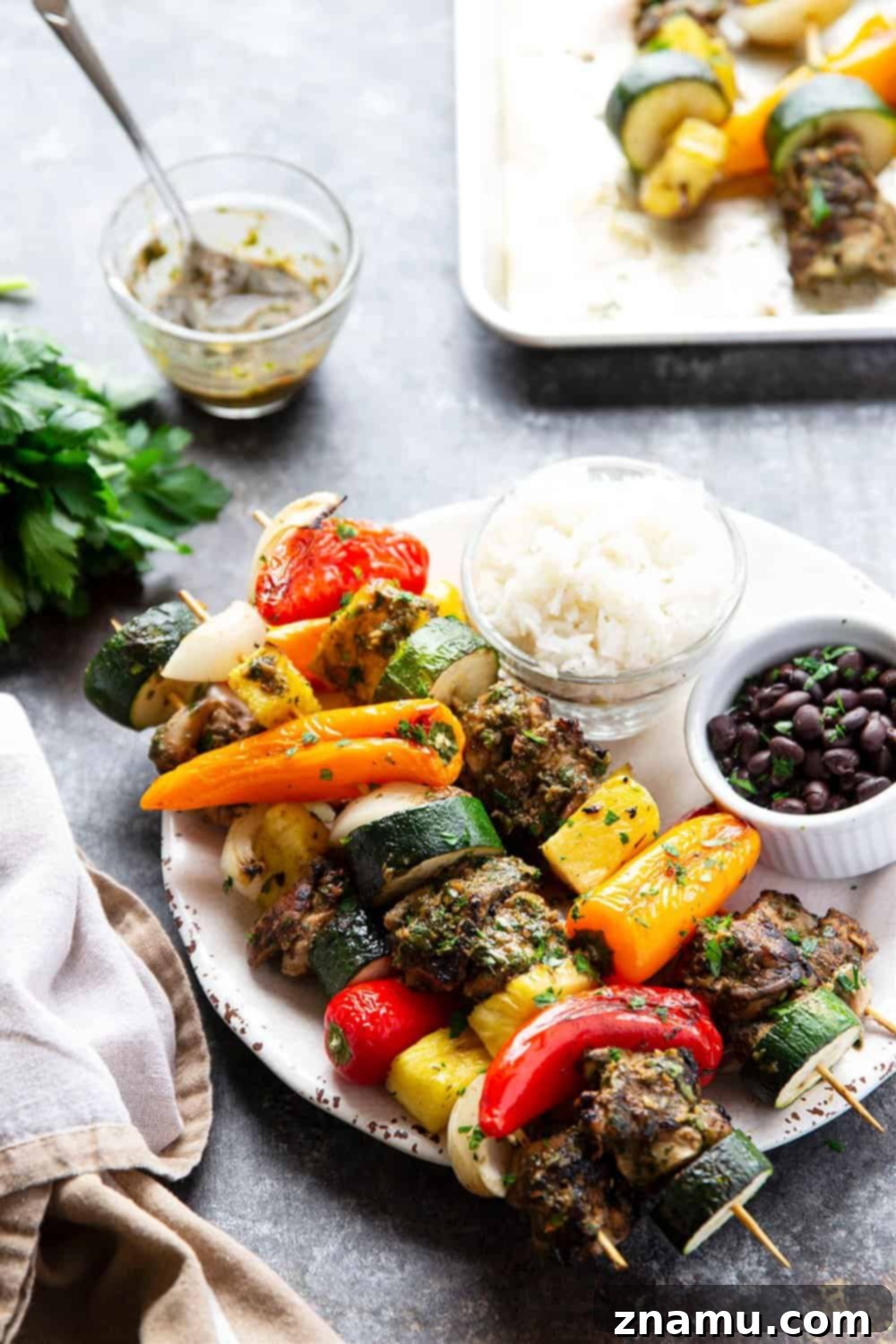 Grilled jerk chicken kabobs feature a spicy homemade jerk marinade coating juicy chicken thighs, sweet pineapple, and fresh vegetables.