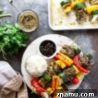 Grilled jerk chicken kabobs feature a spicy homemade jerk marinade coating juicy chicken thighs, sweet pineapple, and fresh vegetables.
