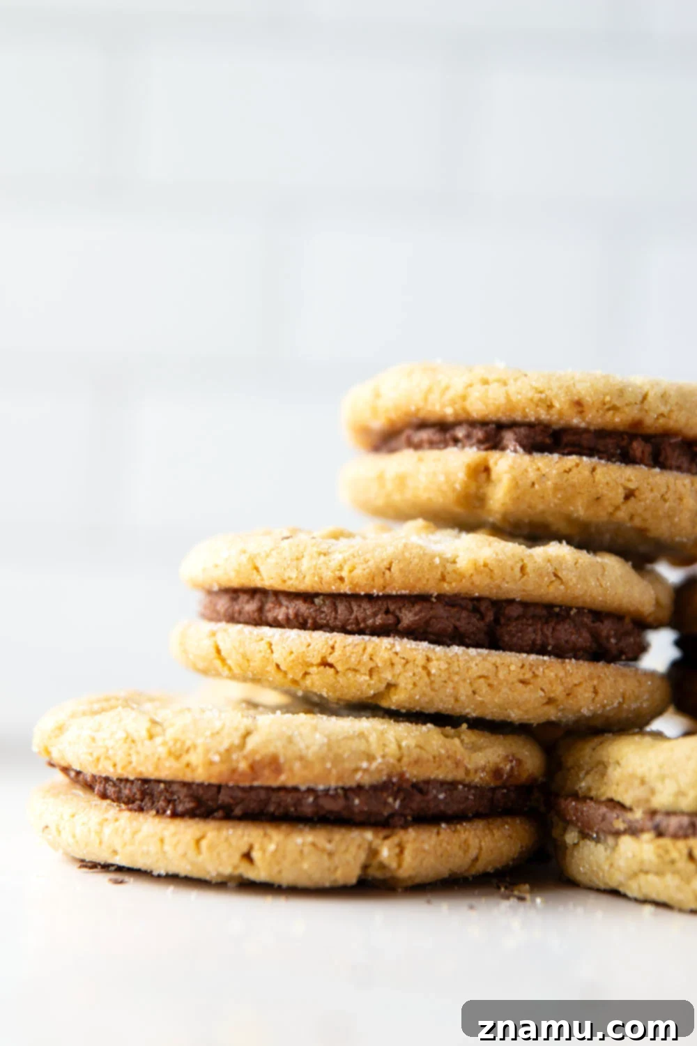 Hand assembling chocolate peanut butter sandwich cookies