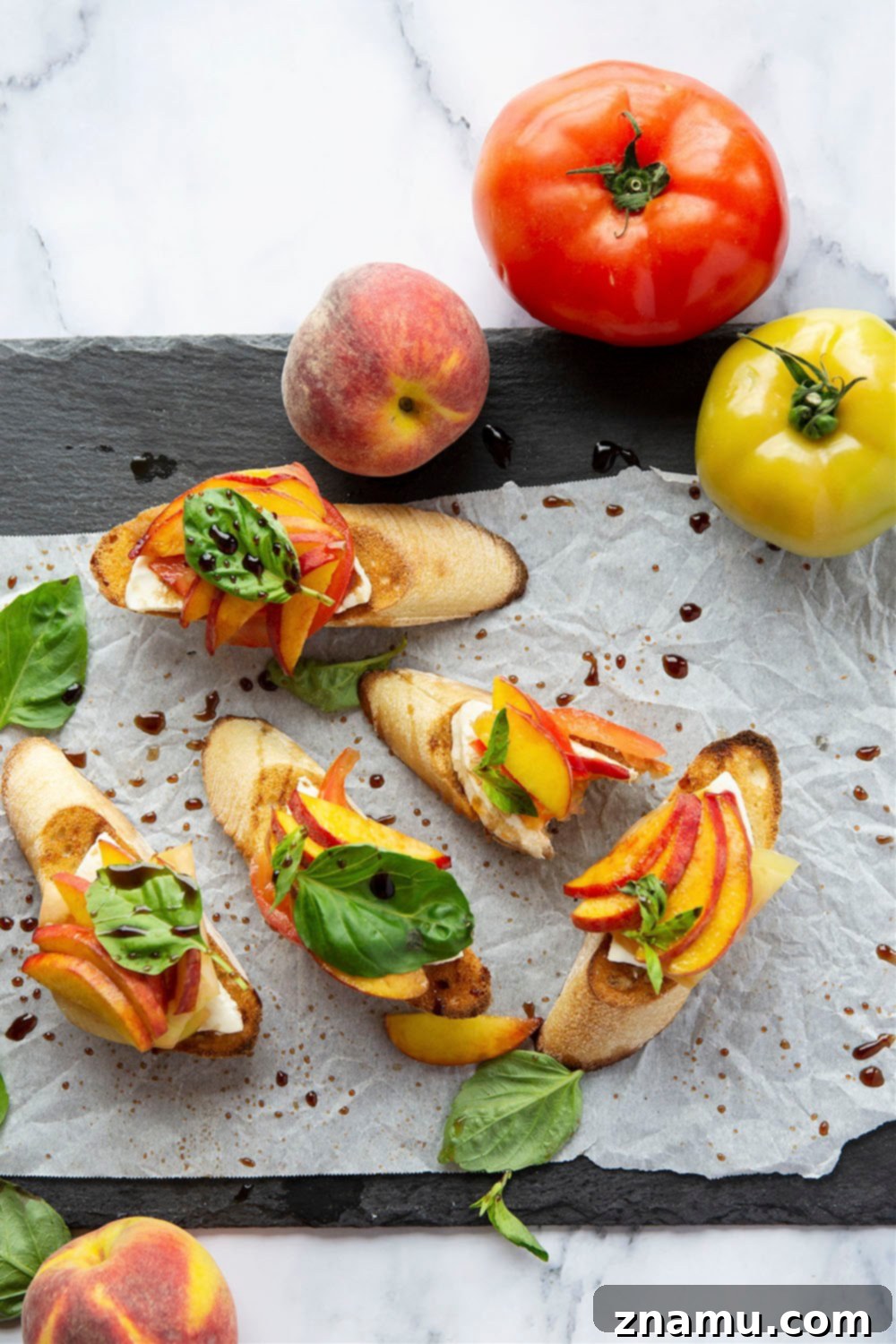 Golden Peach Caprese Toasts 6 Multiple slices of Caprese Peach Bruschetta on a wooden board, ready to be served.