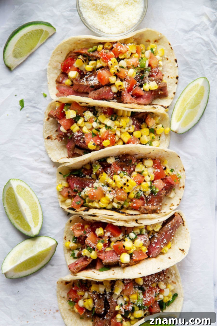 Smoky Chipotle Steak Tacos with Fire-Roasted Corn Salsa 6 Grilled chipotle steak tacos feature juicy grilled steak with a punch of smoky heat and piled high with a flavorful charred sweet corn salsa!