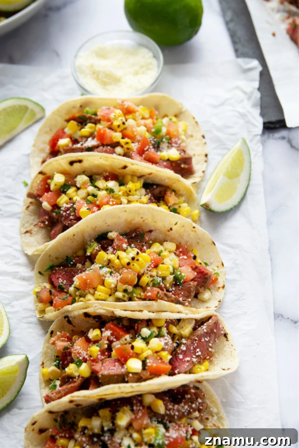 Smoky Chipotle Steak Tacos with Fire-Roasted Corn Salsa 7 Grilled chipotle steak tacos feature juicy grilled steak with a punch of smoky heat and piled high with a flavorful charred sweet corn salsa!