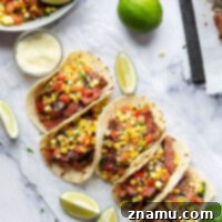 Smoky Chipotle Steak Tacos with Fire-Roasted Corn Salsa 9 Grilled chipotle steak tacos feature juicy grilled steak with a punch of smoky heat and piled high with a flavorful charred sweet corn salsa!