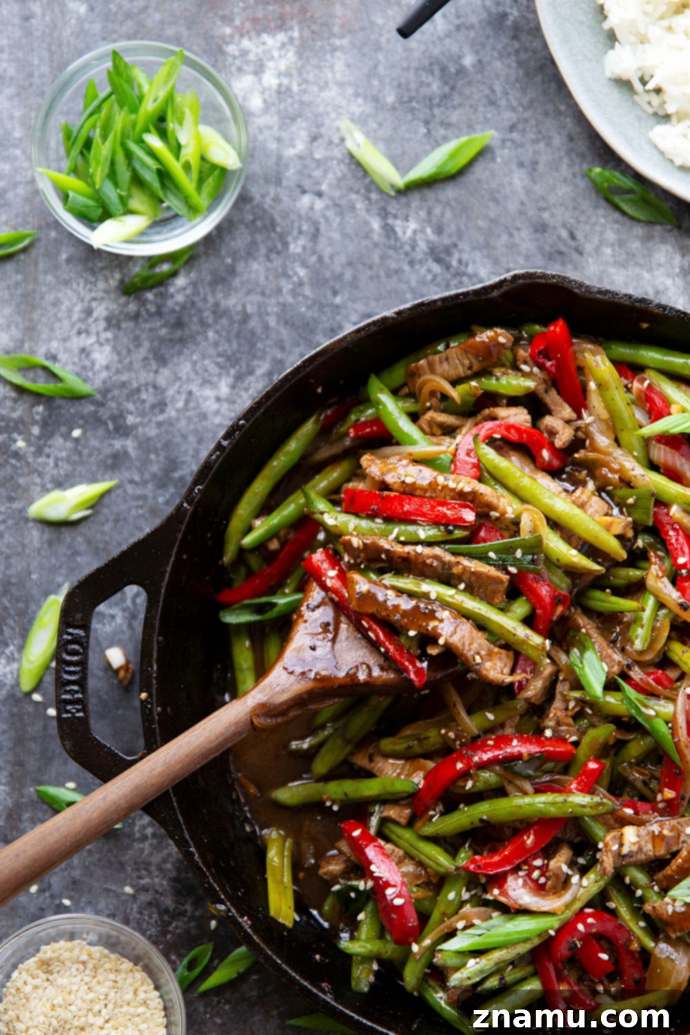 Sticky Ginger-Black Pepper Beef 4 Delicious black pepper beef stir fry garnished with sesame seeds and fresh green onions, ready to be served.