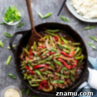 Restaurant-style black pepper beef is loaded with juicy beef strips, tender veggies, and coated in a sticky ginger black pepper sauce.
