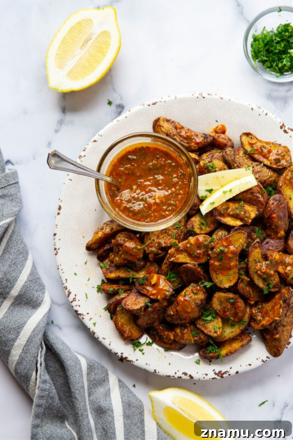 Crispy Air Fryer Fingerling Potatoes with Zesty Harissa Chimichurri 3 Air fried fingerling potatoes with a bowl of vibrant harissa chimichurri for dipping.