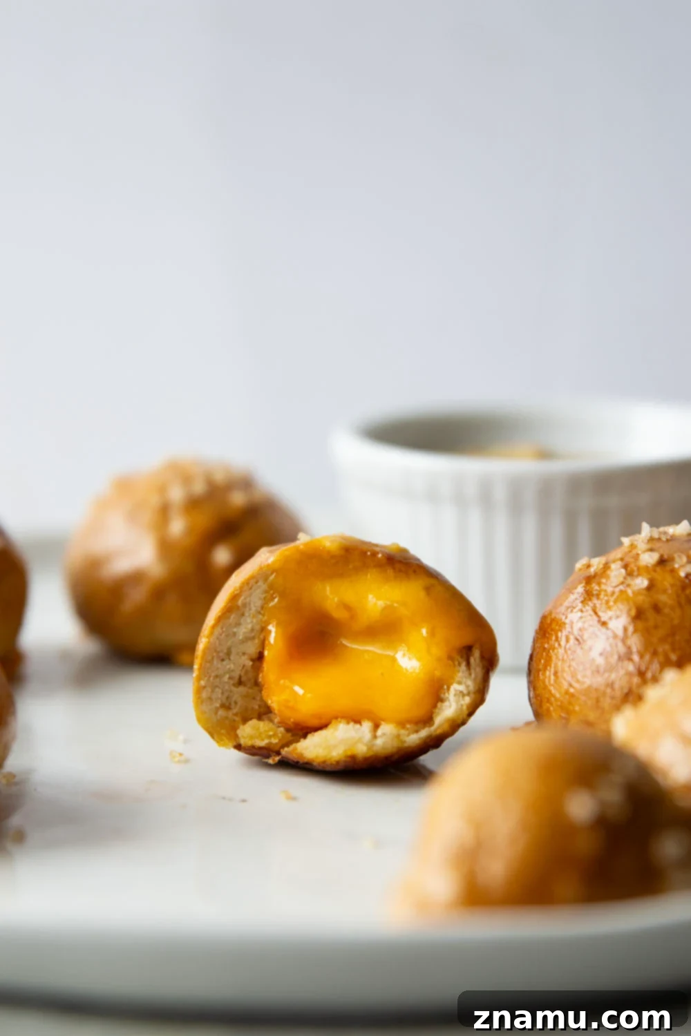 Cheese-Filled Pretzel Poppers 2 These cheese stuffed pretzel bites are ready in under an hour and feature a soft and chewy pretzel interior that's filled with gooey cheddar cheese!