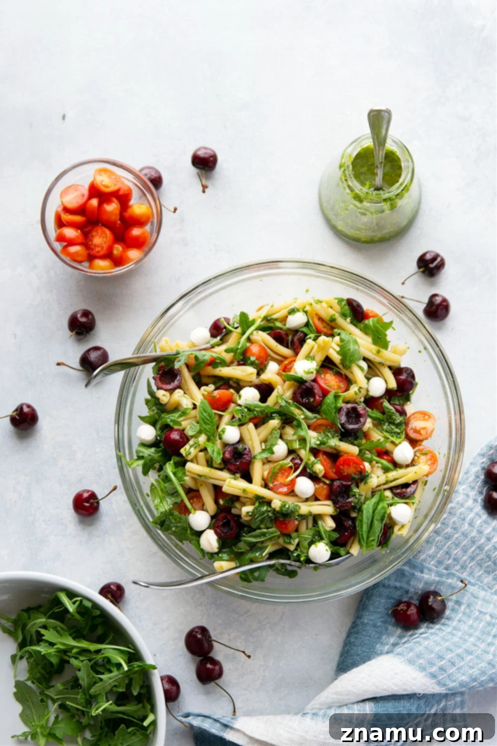 Caprese Pasta Delight: Cherry Tomatoes & Basil Vinaigrette 2 Vibrant Cherry Caprese Pasta Salad, perfect for summer gatherings.