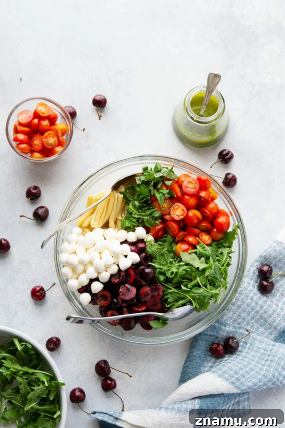 Caprese Pasta Delight: Cherry Tomatoes & Basil Vinaigrette 5 Bowl of Cherry Caprese Pasta Salad, glistening with basil vinaigrette.