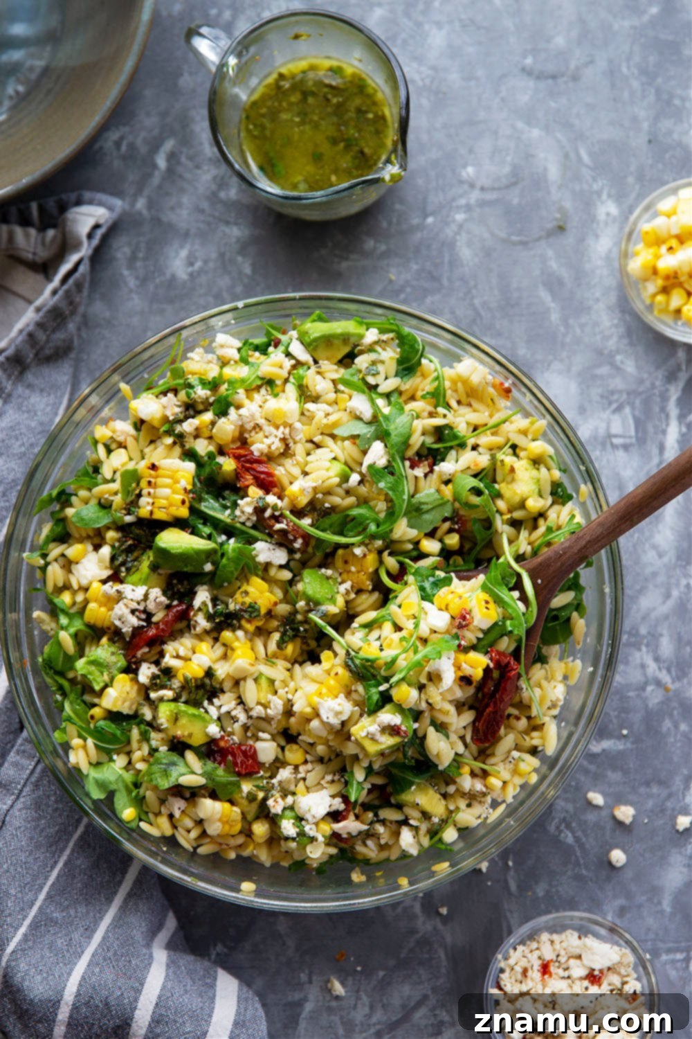 Smoky Corn & Sun-Kissed Tomato Orzo Salad 3 Close-up of the sun-dried tomato orzo salad, showcasing the individual ingredients like orzo, corn, sun-dried tomatoes, and herbs.