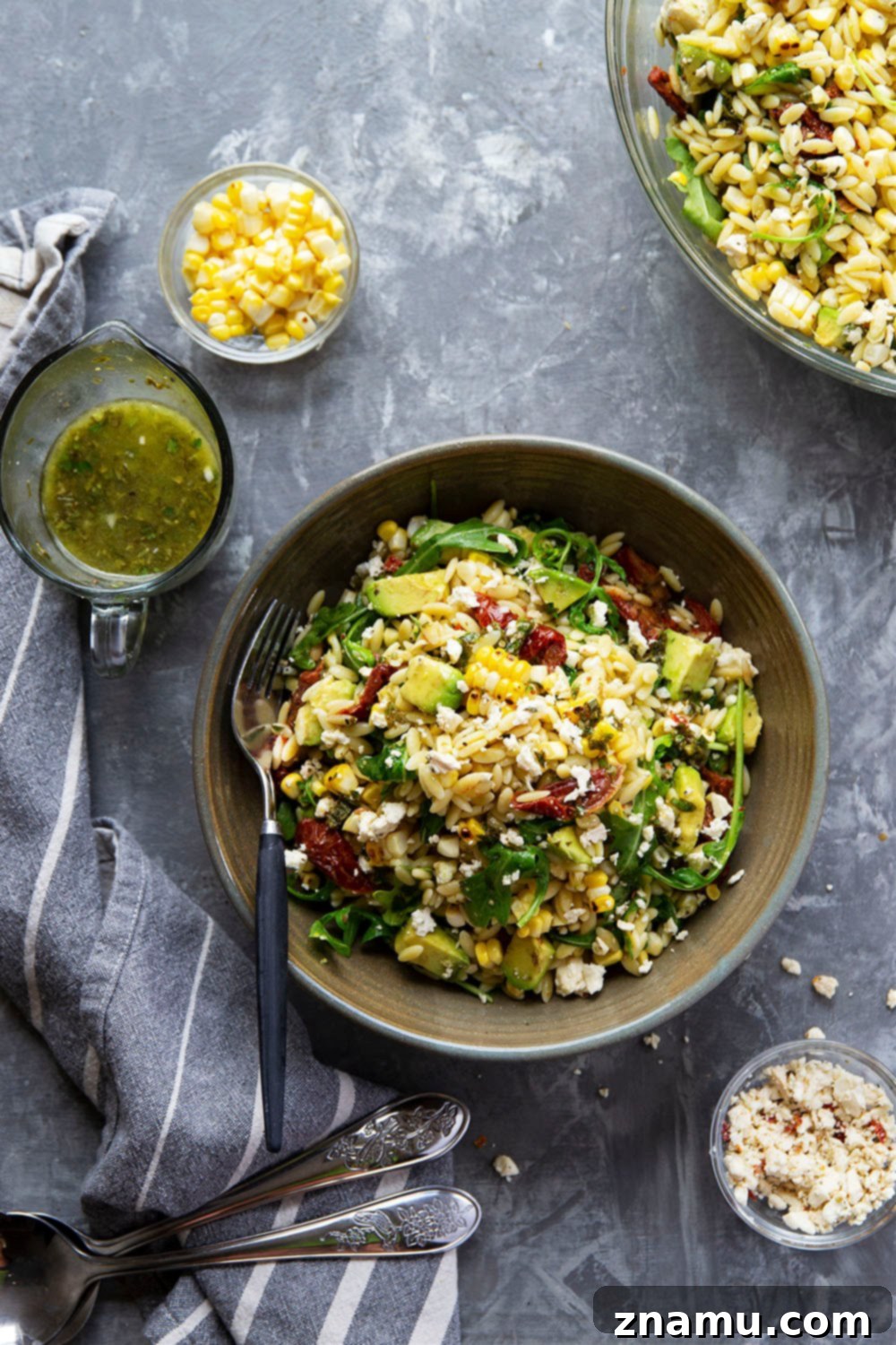 Smoky Corn & Sun-Kissed Tomato Orzo Salad 4 A beautifully plated portion of the sun-dried tomato orzo salad in a small white bowl.