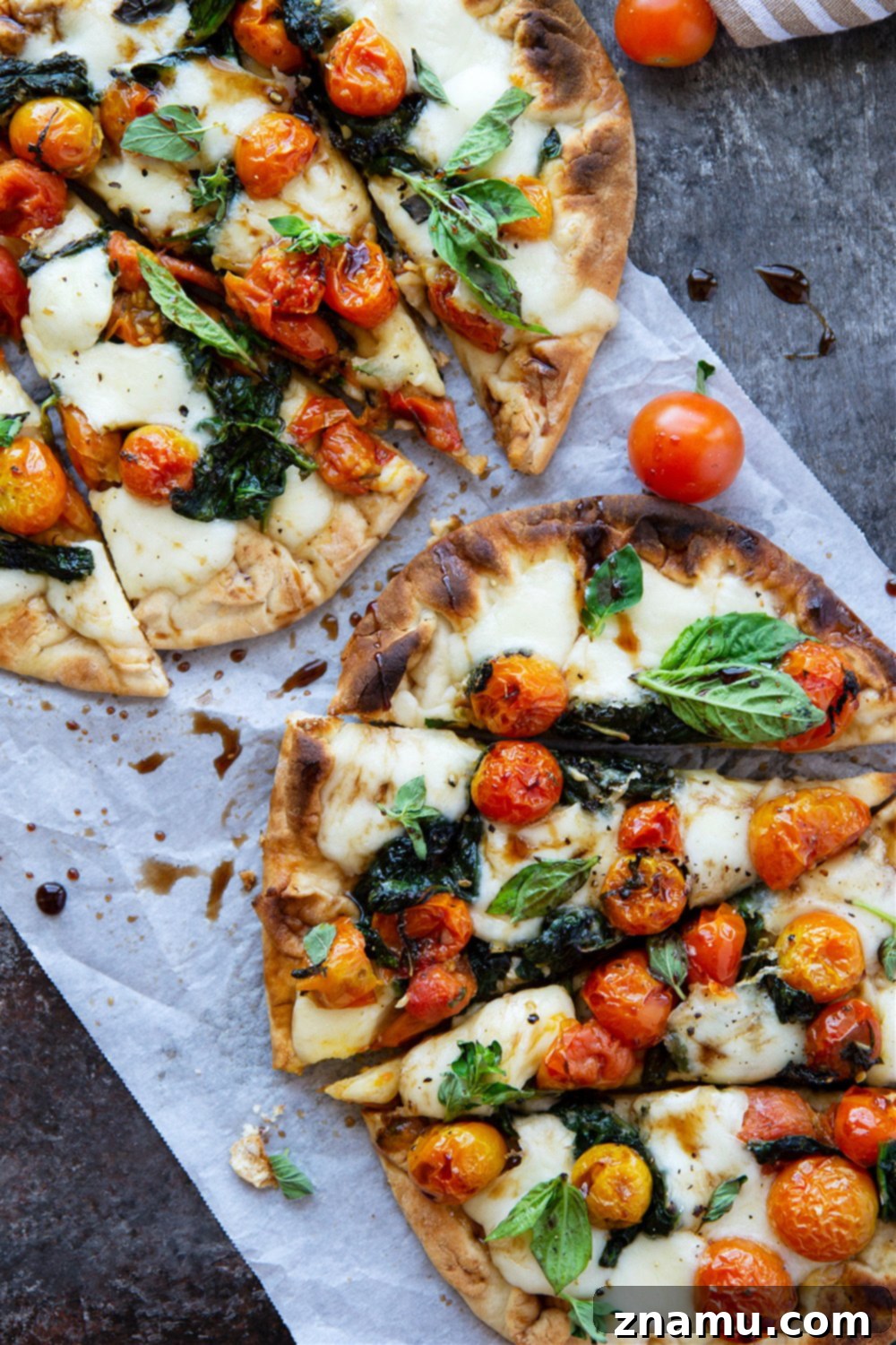 Creamy Burrata Flatbread with Burst Tomatoes and Spinach 6 Full bursting tomato flatbread, cut into wedges, garnished with fresh basil and balsamic glaze.