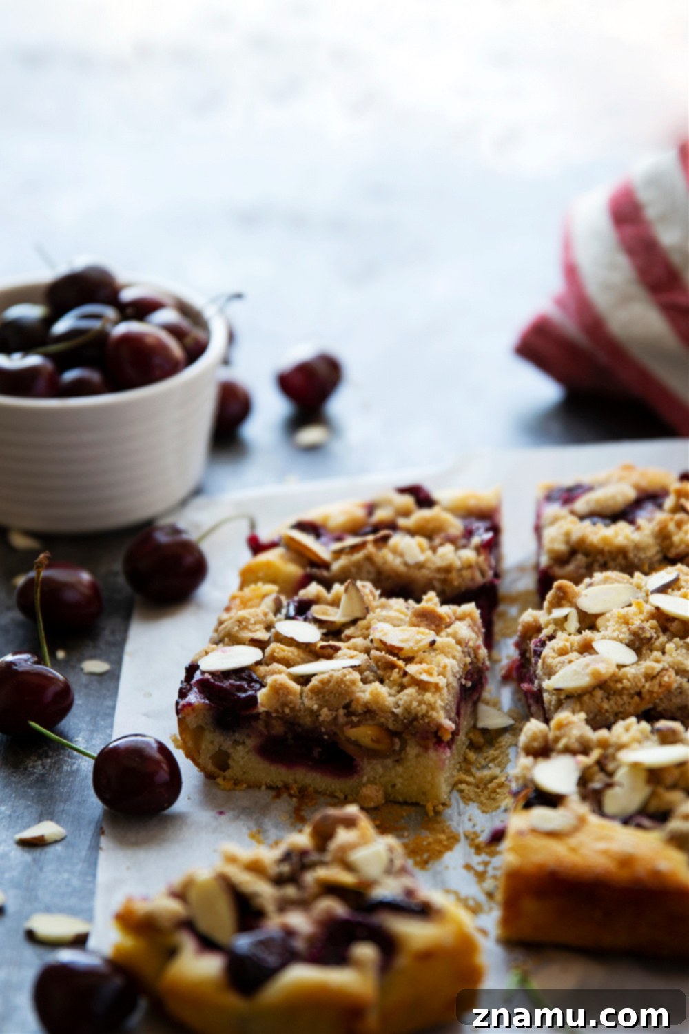 Sweet Cherry Almond Buckle 6 A beautifully sliced Almond Cherry Buckle on a wire rack, ready to be served, highlighting its tender cake, juicy cherries, and crispy topping.