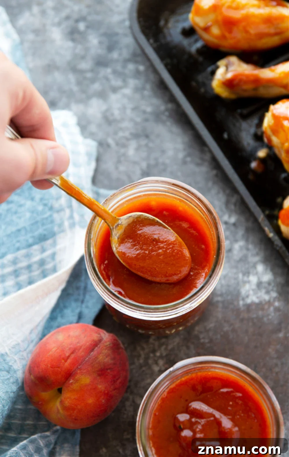 Sweet Heat Peach Chipotle Glaze 6 Several jars of homemade Chipotle Peach BBQ Sauce lined up, ready for storage or gifting.
