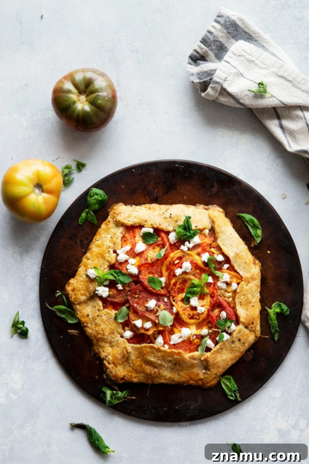Creamy goat cheese and juicy heirloom tomatoes star in this savory tomato goat cheese galette that's a perfect lighter summer lunch or dinner!