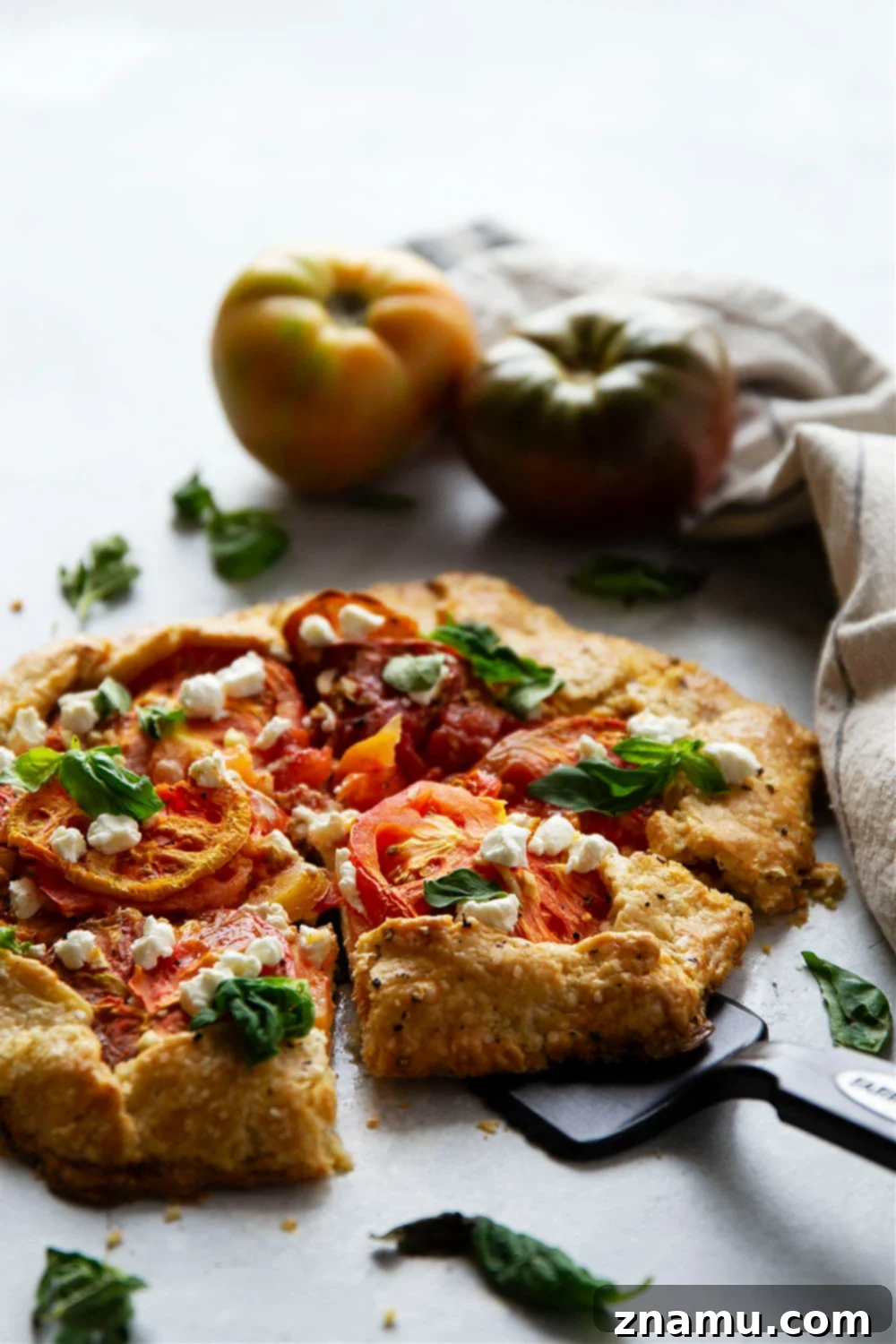 Creamy goat cheese and juicy heirloom tomatoes star in this savory tomato goat cheese galette that's a perfect lighter summer lunch or dinner!