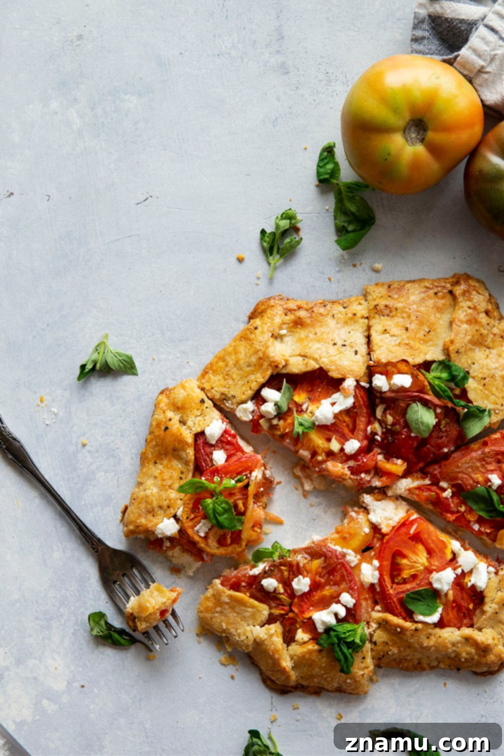 Creamy goat cheese and juicy heirloom tomatoes star in this savory tomato goat cheese galette that's a perfect lighter summer lunch or dinner!
