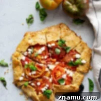Creamy goat cheese and juicy heirloom tomatoes star in this savory tomato goat cheese galette that's a perfect lighter summer lunch or dinner!