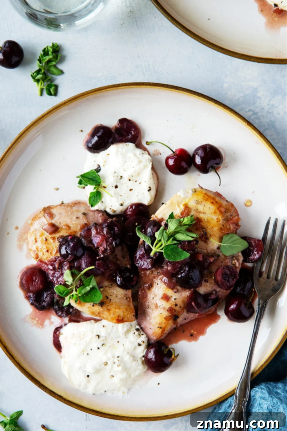 White Wine Cherry Chicken Skillet 3 Close-up of skillet cherry chicken in a white wine sauce with fresh cherries and melted burrata cheese, ready to be served.