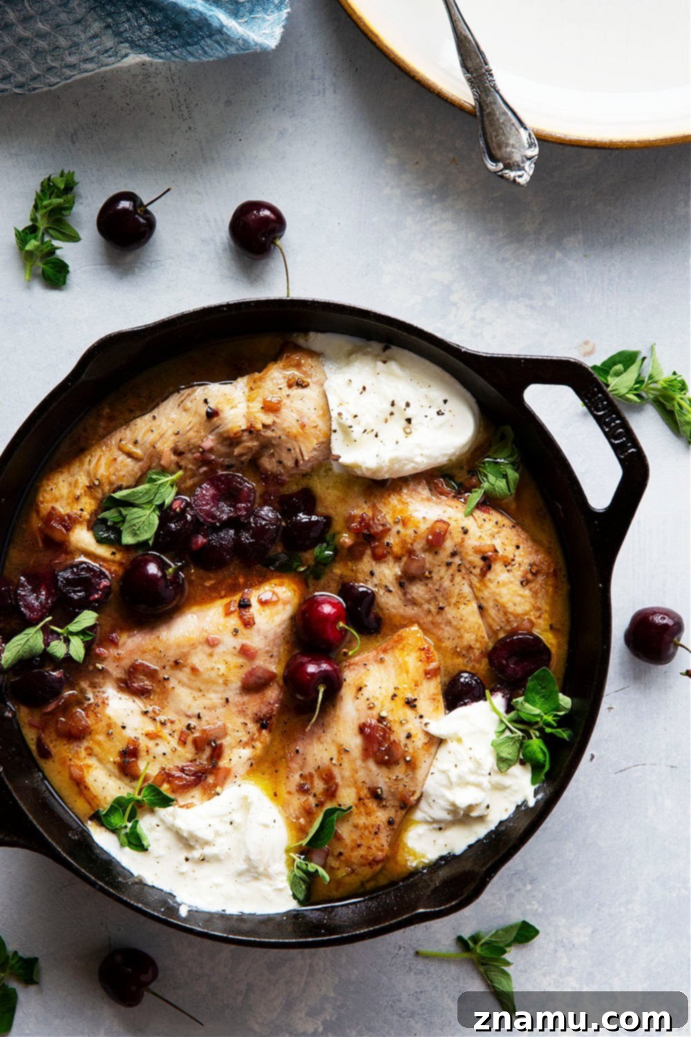 White Wine Cherry Chicken Skillet 4 Close-up of Skillet Cherry Chicken with white wine sauce, fresh oregano, and burrata cheese, illustrating the dish's vibrant colors and textures.