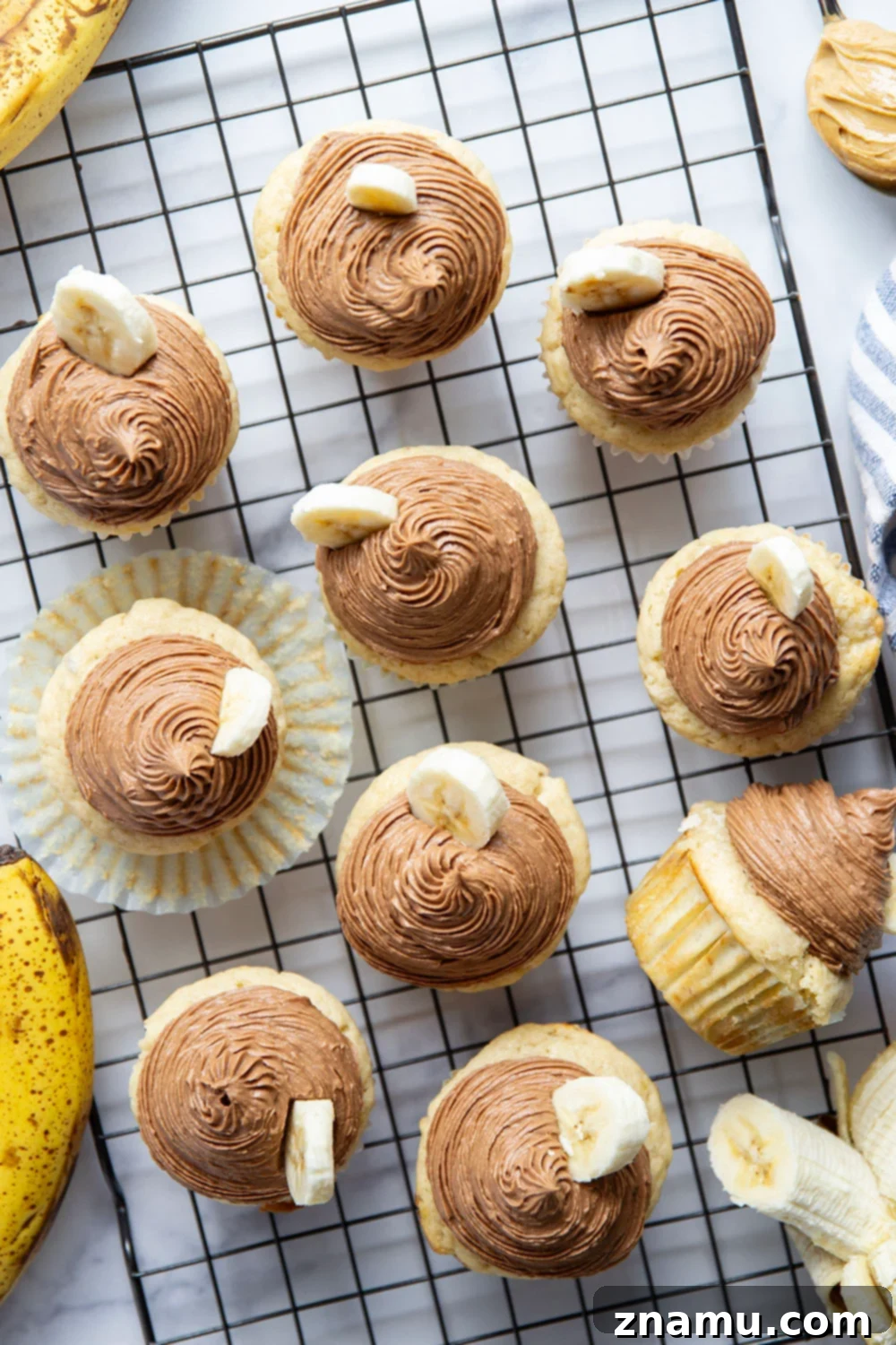 Rich Banana Cupcakes with Decadent Chocolate Peanut Butter Frosting 2 Super moist and fluffy banana cupcakes with chocolate peanut butter frosting piped high on top