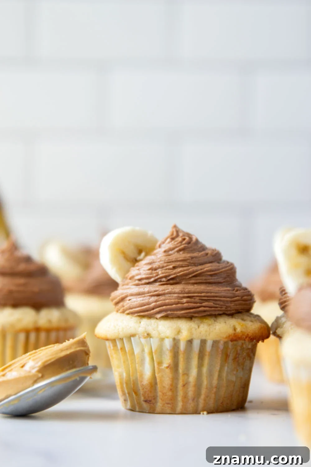 Rich Banana Cupcakes with Decadent Chocolate Peanut Butter Frosting 3 Close-up of fluffy banana cupcakes with chocolate peanut butter frosting
